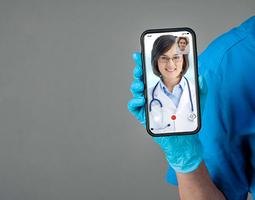 A female doctor holding a phone
