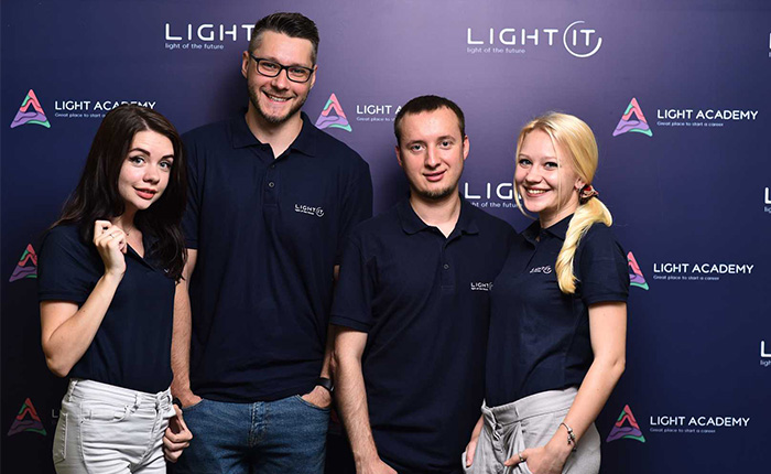 Four colleagues in corporate polo shirts