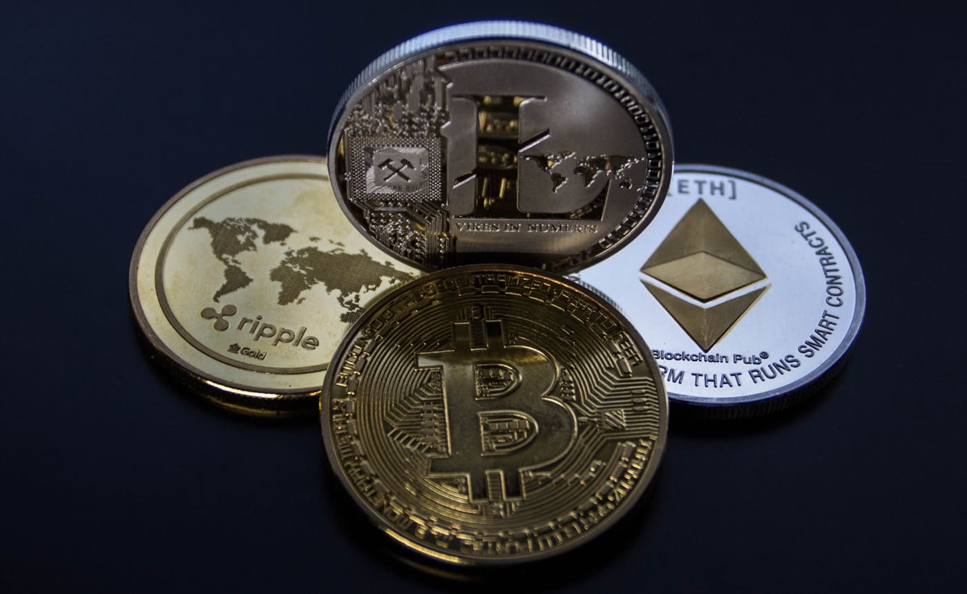 Four types of cryptocurrency presented as metal coins