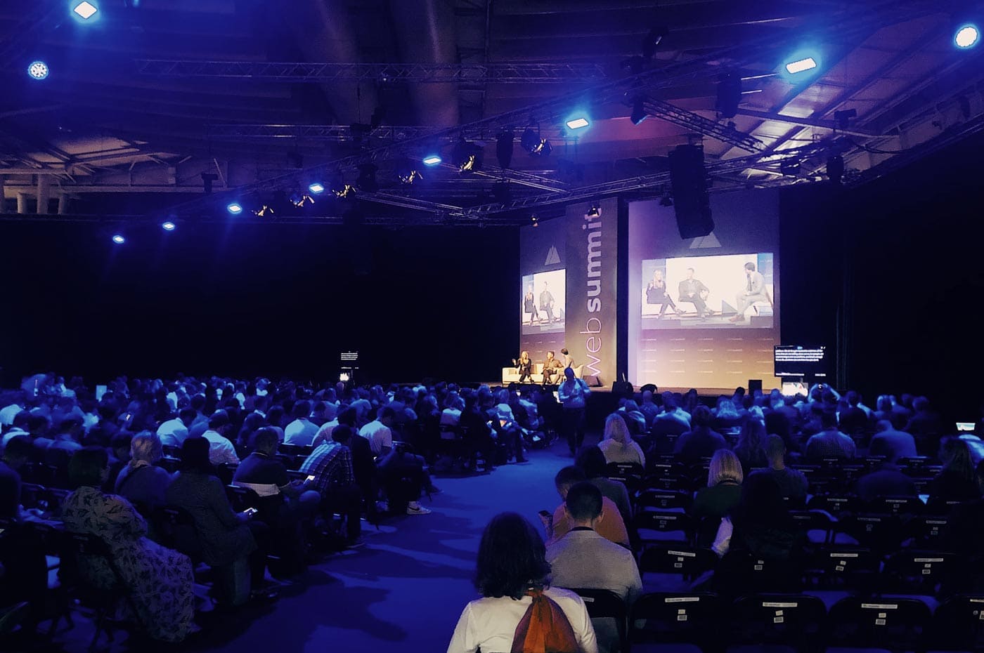 People listen to speakers at web summit